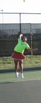 Junior Angela Tsang serves the ball during one of her practices. 