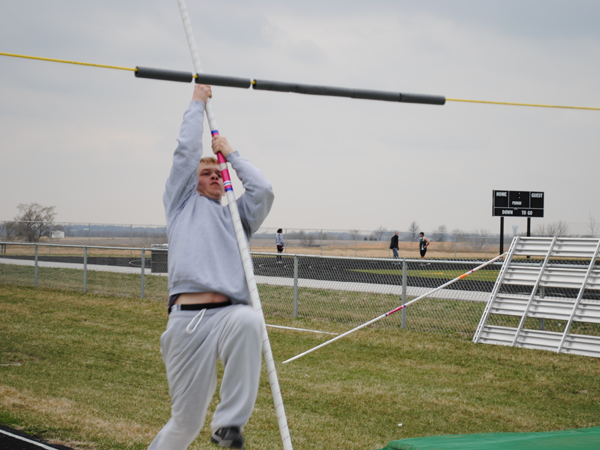 Sophomore Tucker King drives the pole into the ground, concentrating of his practice vault, not the possibility of landing on the old mice nests.