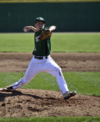 Varsity pitcher, junior Colin Frederick pulls his arm back for a pitch. Frederick assisted in a 6-0 win for tte Timberwolves against the Shawnee Mission North Indians.