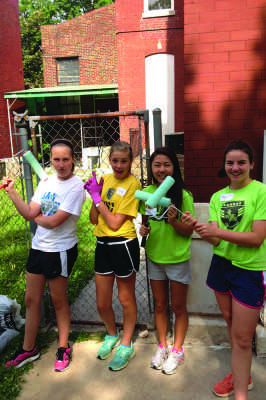 Sophomore Abby Yi (second from right) and her fellow volunteers  repainted the children’s center ‘s fading and chipping exterior.  Along with painting, the volunteers also gardened the overgrown plants.  
