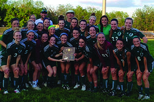 Soccer players pose for a photo after winning a big game.