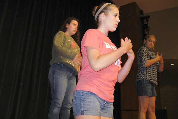 Choreographer Tori Loepp checks her dancers as they run through their Jungleland dance.