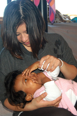 Geegee plays with her baby Emmie in her bedroom.