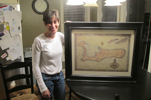Cathy Schrag stands in front of her map of Grand Cayman, the largest island of the Cayman Islands.