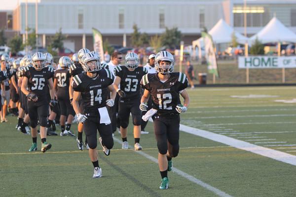 The football team takes the field.