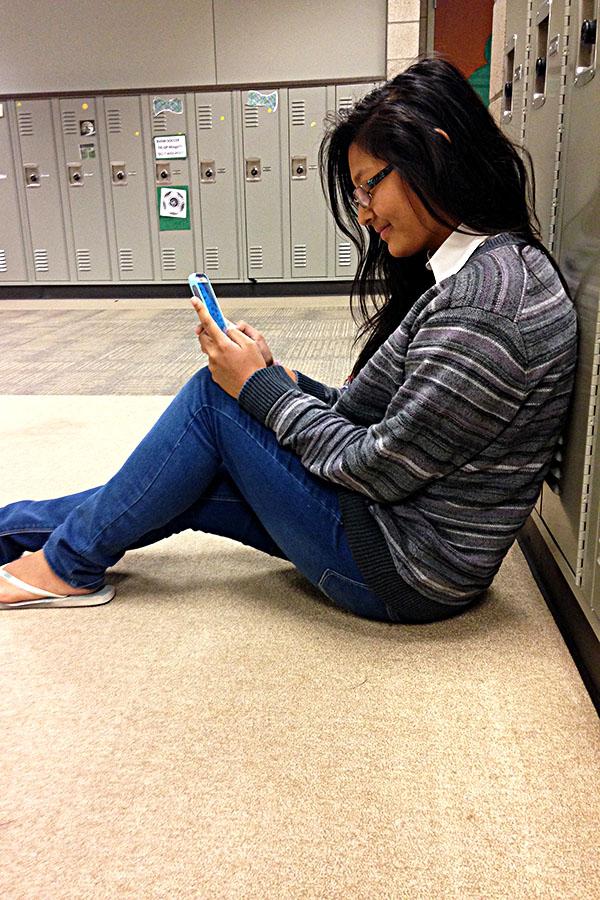 Sophomore at Southwest, Amira Bajracharya, takes a seat to check her messages.