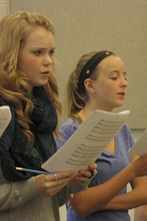 Junior Emilie Dayton and new sophomore Laura Fotovich singing a new piece in preparation for the first choir concert of the new year.
