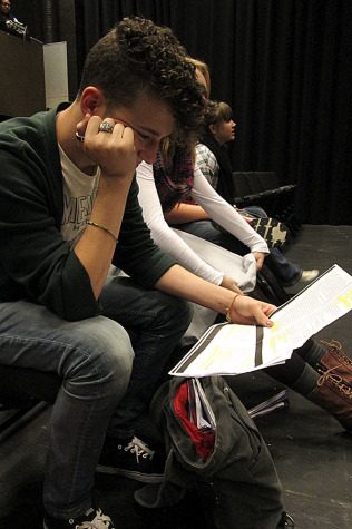 Junior Sam Kalmus studies his lines in preparation for the show.