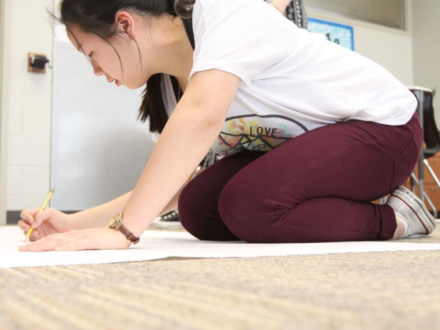 Prom committee member junior Christina Cornell makes posters to advertise Prom.  