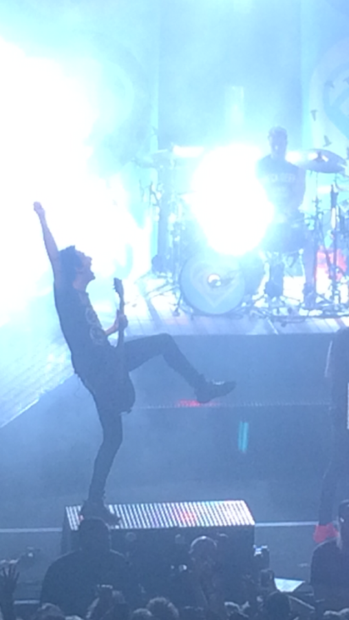 Guitarist and back-up vocalist Jack Barakat of All Time Low strums his guitar during the end of Lost In Stereo. Photo by sophomore Lauren Haught.