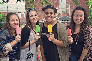 Juniors Libbie Louis and Erin Thompson, senior Brea Clemons and alumnus Amanda Miller enjoy popsicles at Porchfest as they venture to the next porch to hear more music. 