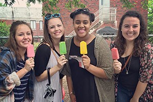 Juniors Libbie Louis and Erin Thompson, senior Brea Clemons and alumnus Amanda Miller enjoy popsicles at Porchfest as they venture to the next porch to hear more music.