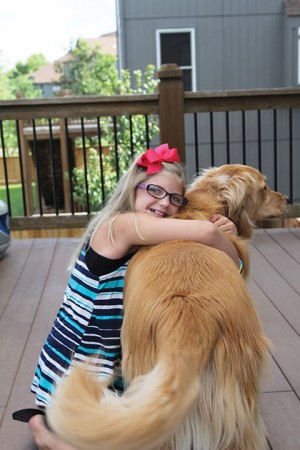 Zoe hugging dog