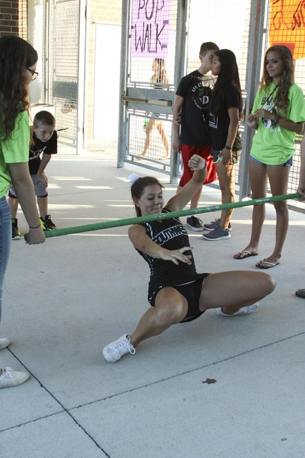 Junior Lindsay Hissong tries to maintain her balance as she competes in the limbo contest. 