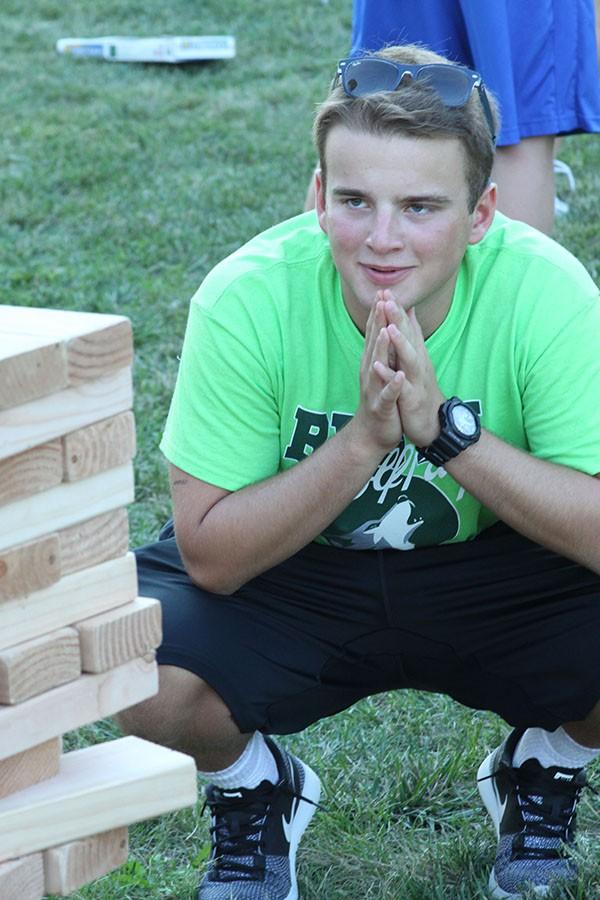 Junior WPC member Ryan Davis carefully observes the Jenga tower before making his move. 