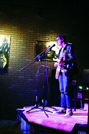 Junior Travis Hampton plays his guitar at slam nights. Hampton has encouraged his friends, such as junior Alex Norcoss, to perform at slam nights as well. 