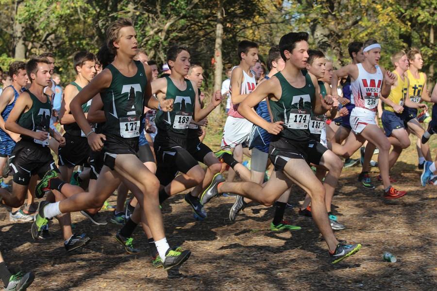 Racing to the finish, sophomores Weston Evans and Jared Lefert fight for fifth place. Evans (on the left) placed fifth in the boys JV race with a time of 18:29.2 and Lefert placed sixth with a time of 18:29.3. 