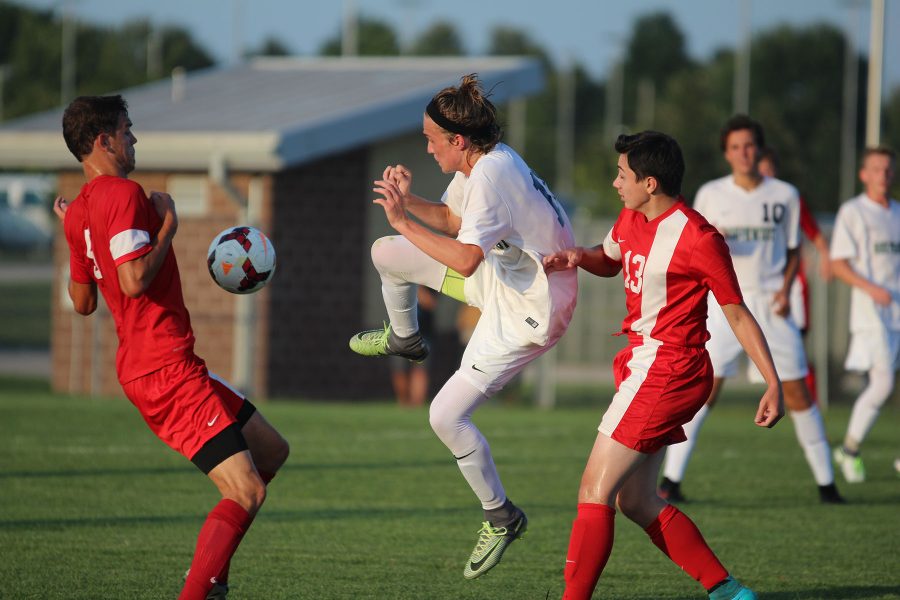 Junior Matthew Weaver jumps in the air to kick the ball towards the goal.