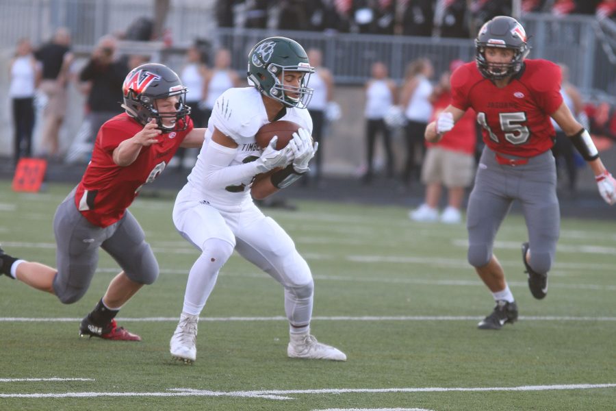 Number 21 senior Daniel Foulon catches the ball in the first quarter for a first down. 