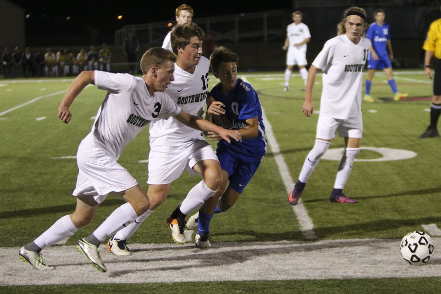 Number three junior Cole Petri and number 13 senior Brady Dow fight an opponent to gain control of the ball.  