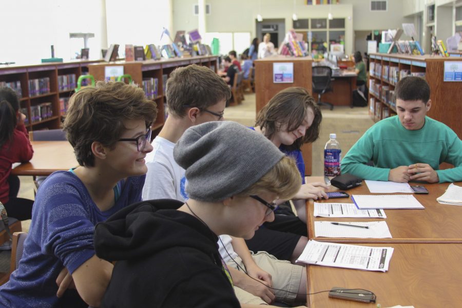 Freshman Oliva Nelson, freshman Brianna Studna, sophomore Logan Hunter and sophomore Will Kennedy enjoy spending their late arrival in the library playing table top RPGs.