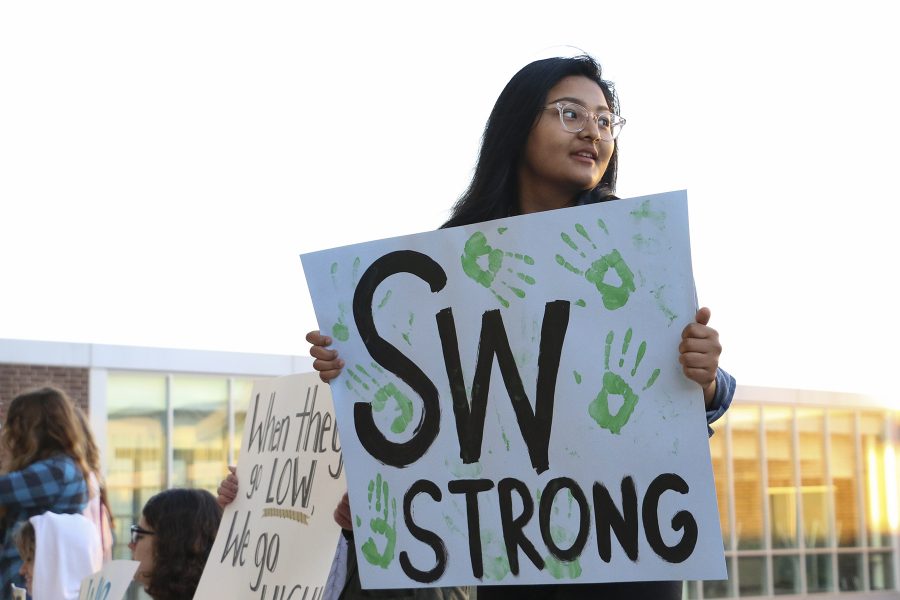 Holding up her sign, senior Amira Bajracharya particpates in a peaceful rally. 