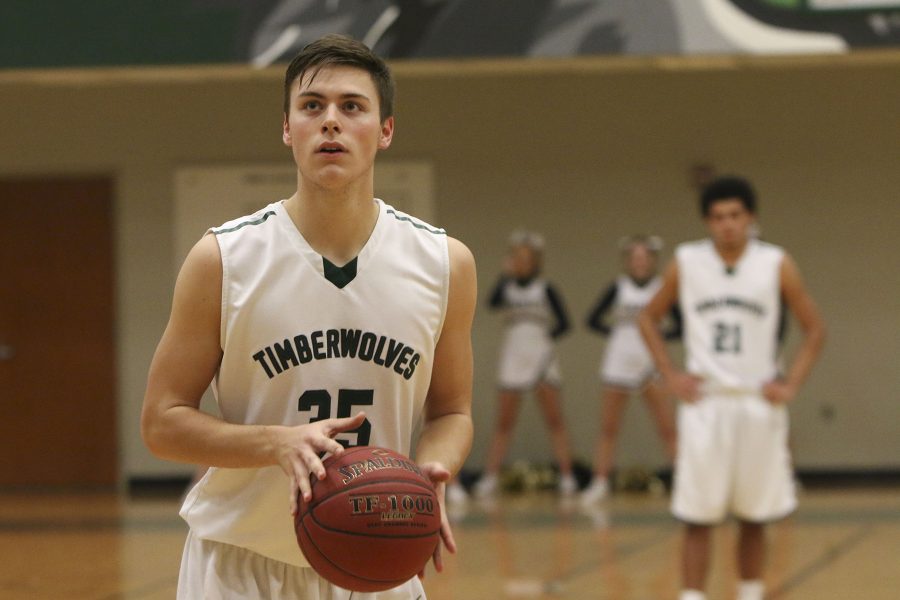 After being fouled by an Aquinas player, senior Nathan Gish shoots a free throw shot. 