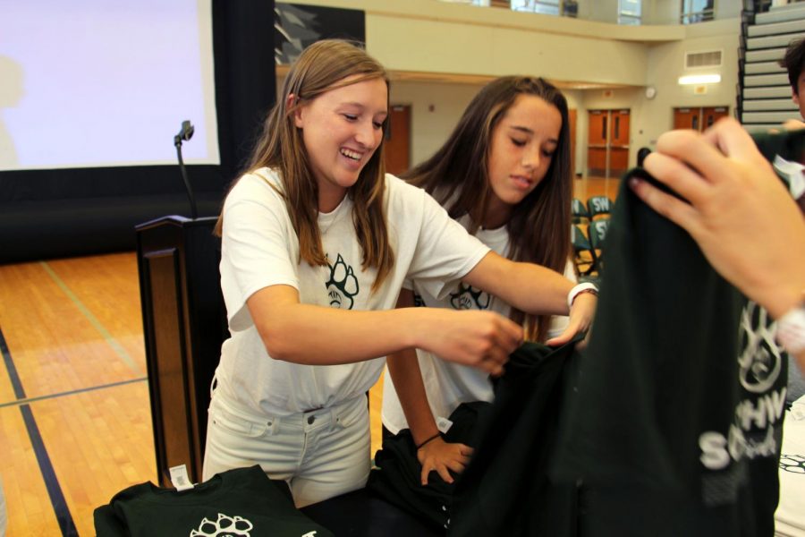 Organizing the Green and White T-shirts, senior Kori Stonestreet prepares for the third assembly of the year. WPC members planned and put on the assembly on Aug. 24.