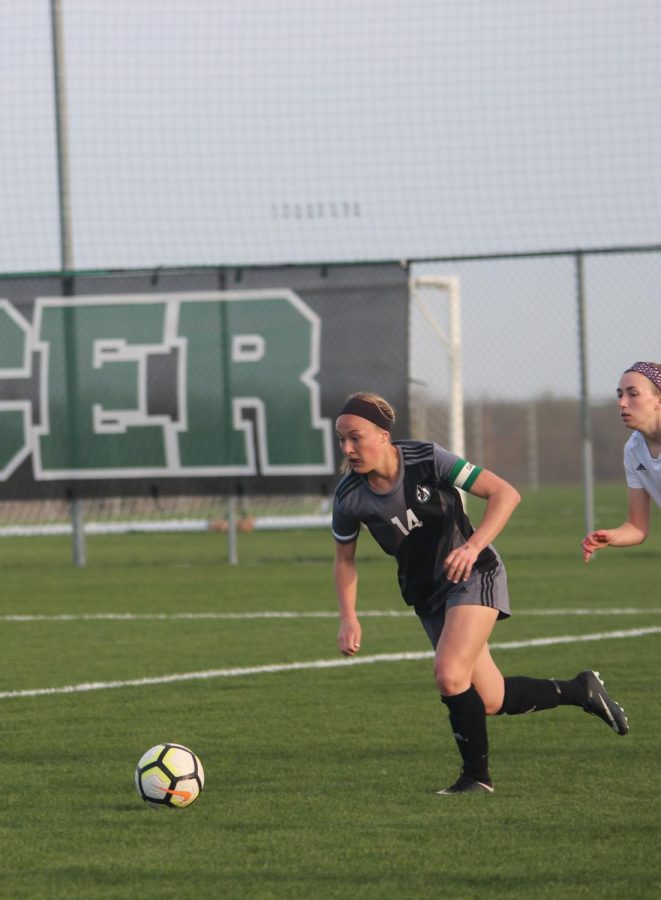 Running to the ball, senior Calista Schechinger beats the defender to gain possession over the ball. 
