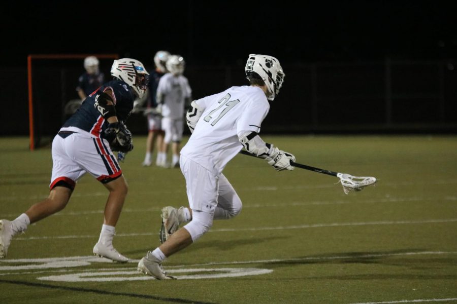 During the face-off, Blue Valley Northwest junior, Leo Clennan runs to the ball.