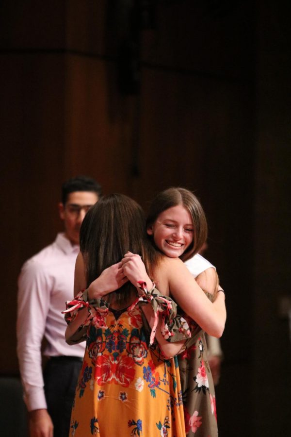 With open arms, senior Kendall Rintamaki hugs Ashley Schueler in celebration.