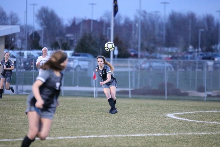 Eyes on the ball, sophomore Ashley Lamfers clears it across the field.