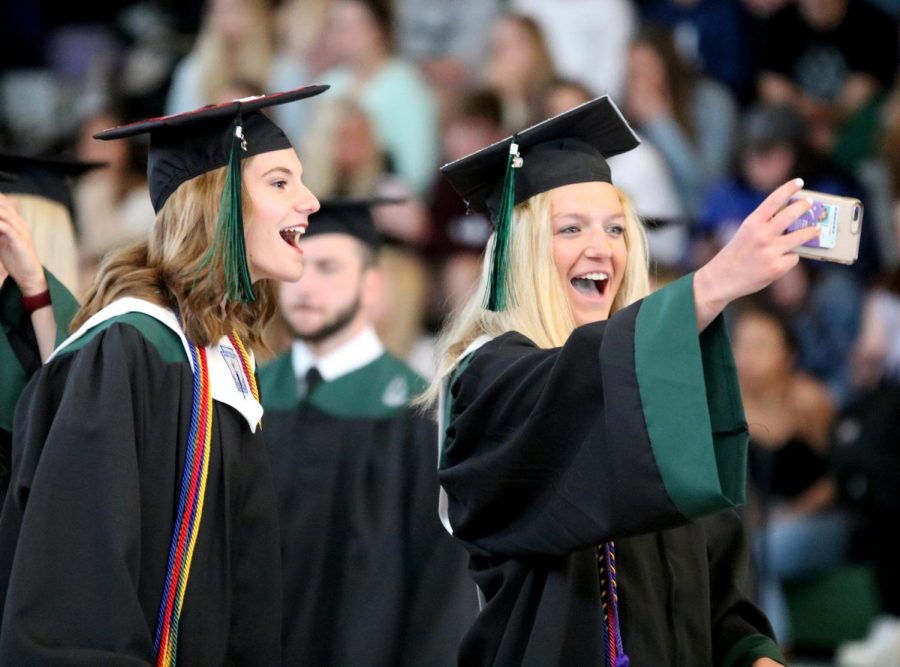 As they leave Class Day, seniors Nicole Barber and Caroline Ayres take a selfie. 