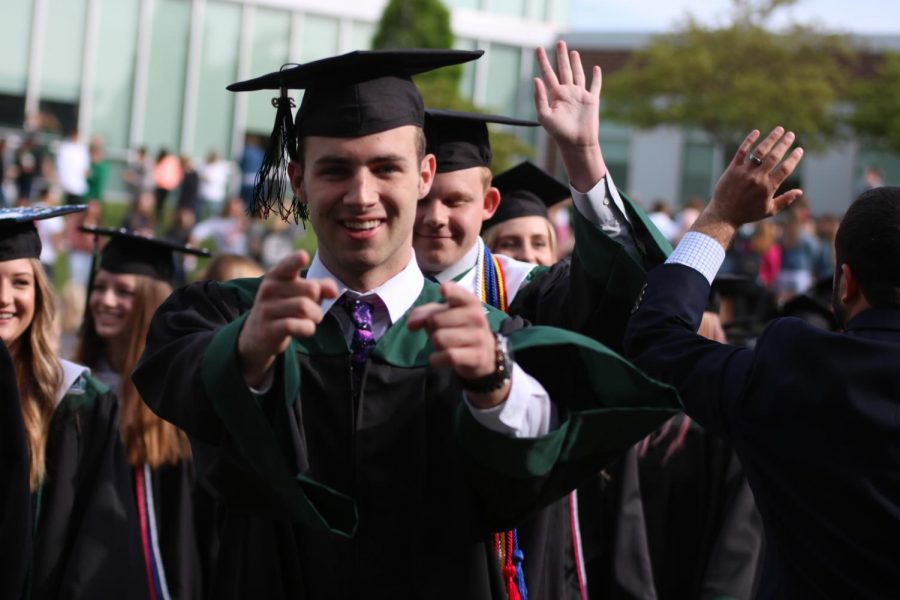 While walking with his class, senior Tommy John Scanlon points at the camera. 