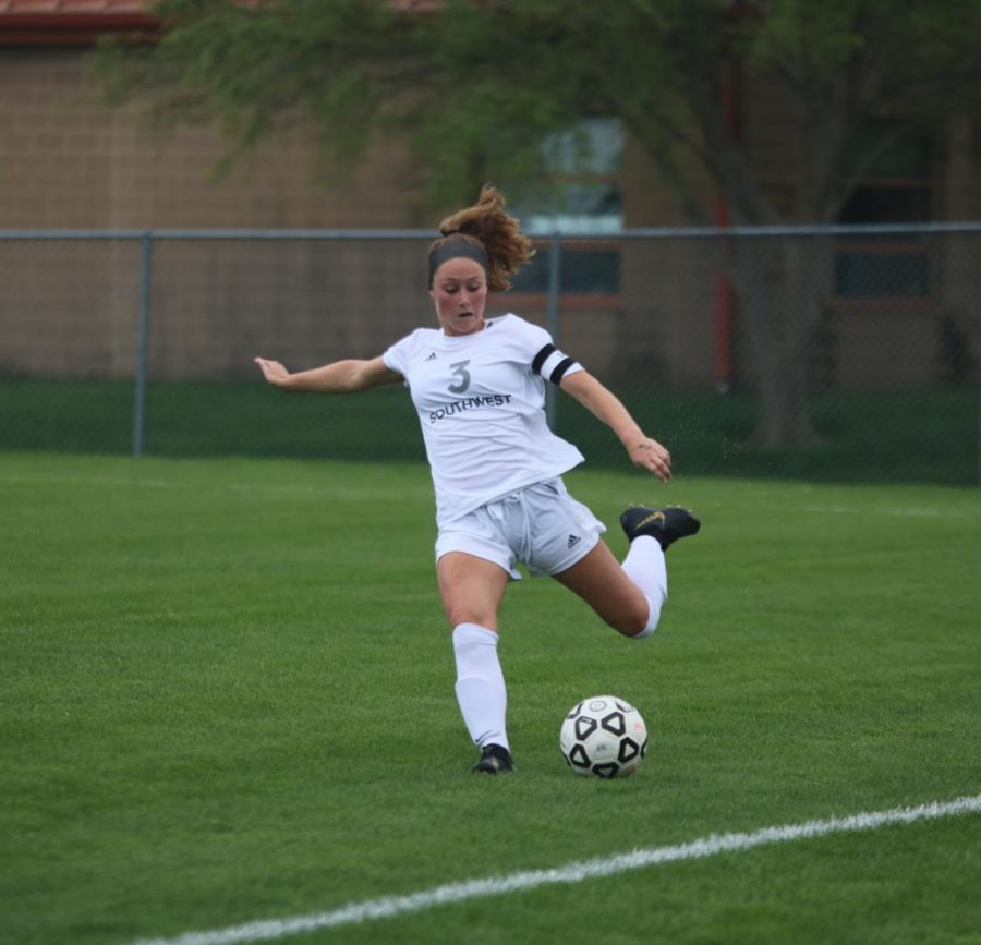 Looking to get rid of the ball, senior Macy Ruffalo passes it away. 