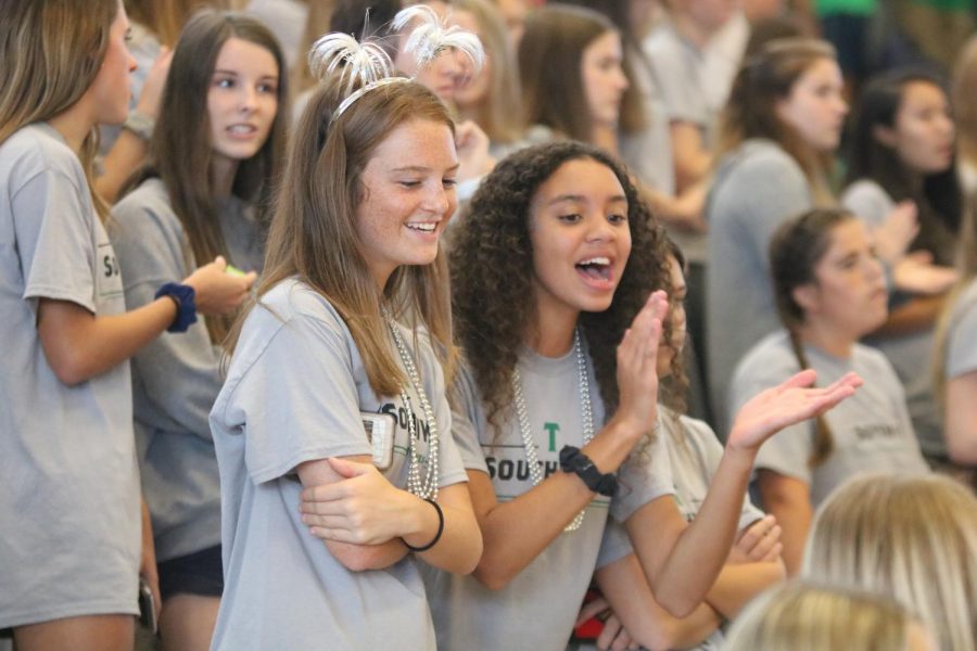 Sophomores Tamerra Gantt and Hunter Hartwegar cheer on the fall sports teams from the bleachers during the Fall Sports Assembly on Sept. 20.

