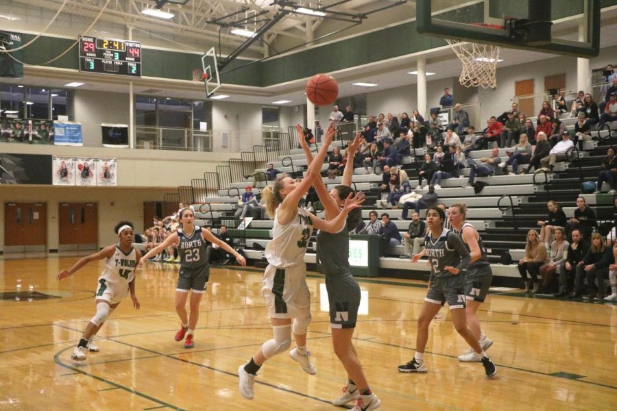 Senior Maddie Garretson reaches for the ball in an attempt to make a shot.