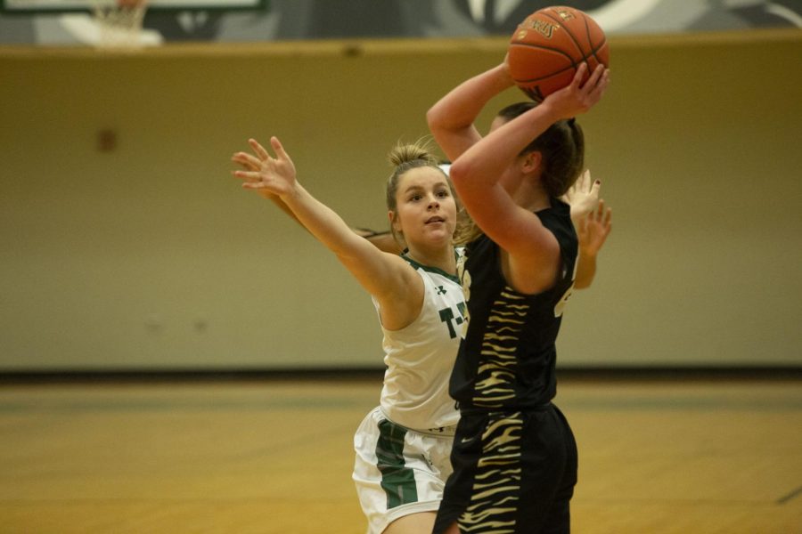 Senior Peyton Justice moves in front of her opponent to block a pass.