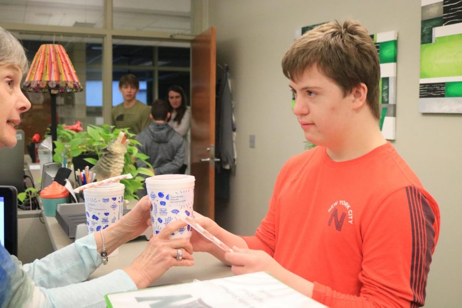 Junior Gabi Ricci delivers a Sonic drink to athletic administrative assistant Diane Murdock.