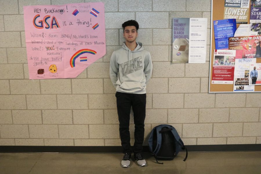 Senior exchange student Yawar Khan poses for a photo in a hallway.