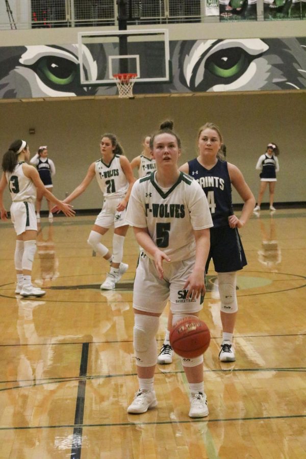 Girls Varsity basketball player sophomore Abby Augustine prepares to make a foul shot at the game on Feb. 11 2020.