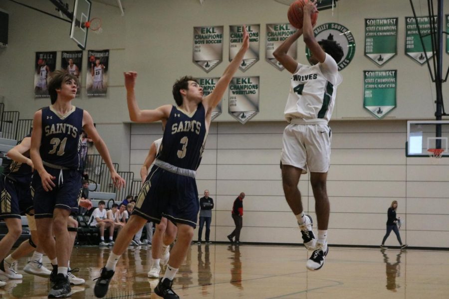 Junior Shay Patel takes the jump shot despite the opposing player