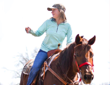 Senior Lucy smiles while sitting on top of her horse during one of her practices.