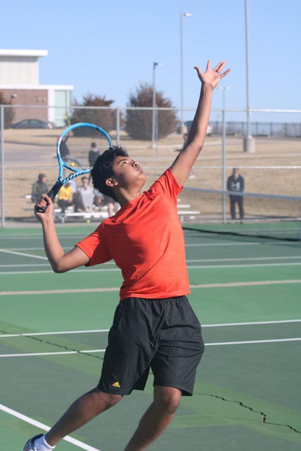 Getting ready, freshman Vishal Rajkumar serves the ball at practice on March 5. The tennis team competed in a pre-season tournament before spring break. Photo by Sydney Wilson.