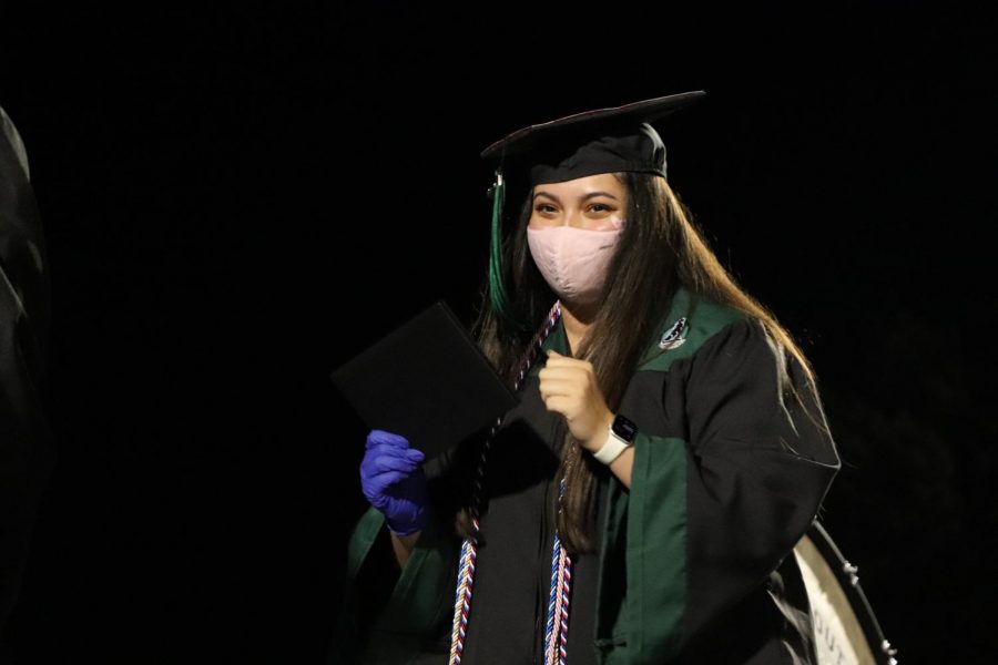 Holding her diploma, senior Josette Pinto walks across the stage. Pinto served as student council president her senior year. Photo by Lianna Shoikhet.