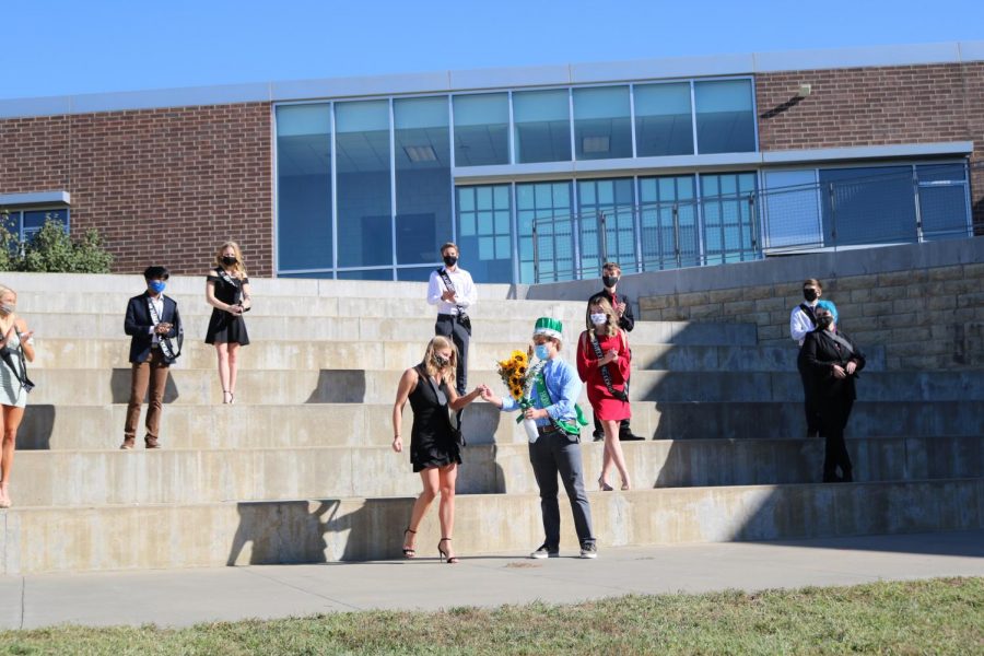 With her peers applauding her in the background, senior Megan Hanahan steps down from her place after being announced as  Homecoming Queen.