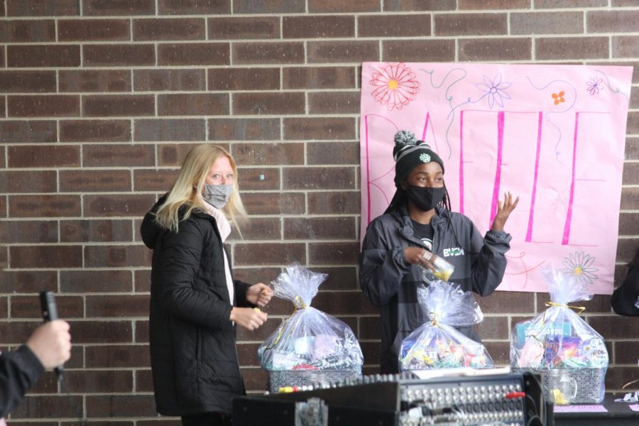 Senior Merritt Ellis  walks up to the raffle table to accept her prize from senior Emily Ervin.