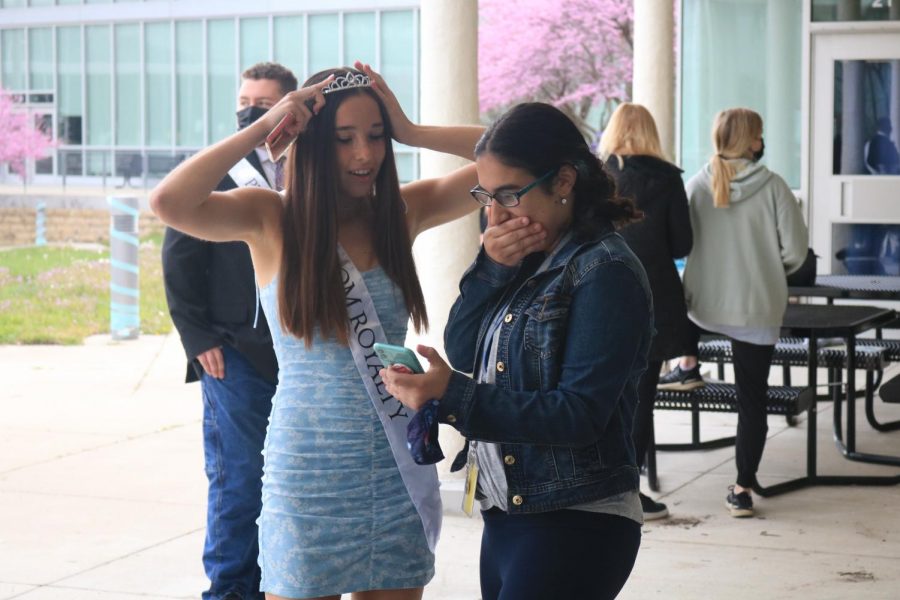 Senior Jaylie Hicklin looks at photos with junior Monica Hura.