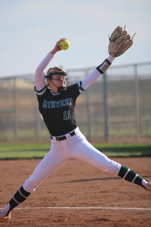 Sophomore Sophie Brickman leaps forward and swings her arm to pitch the ball.