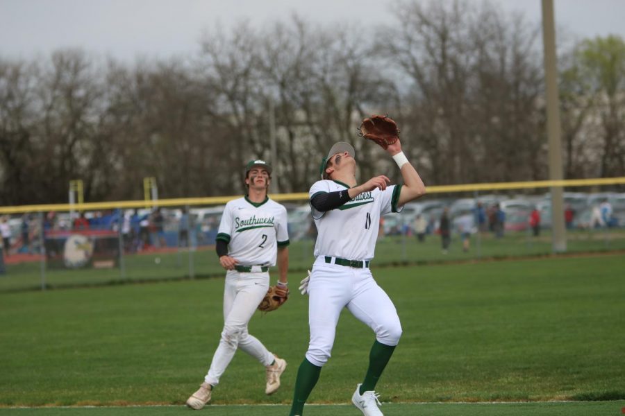 Senior Carson Hornung calls off junior Cooper Kelly on a fly ball in shallow left field.